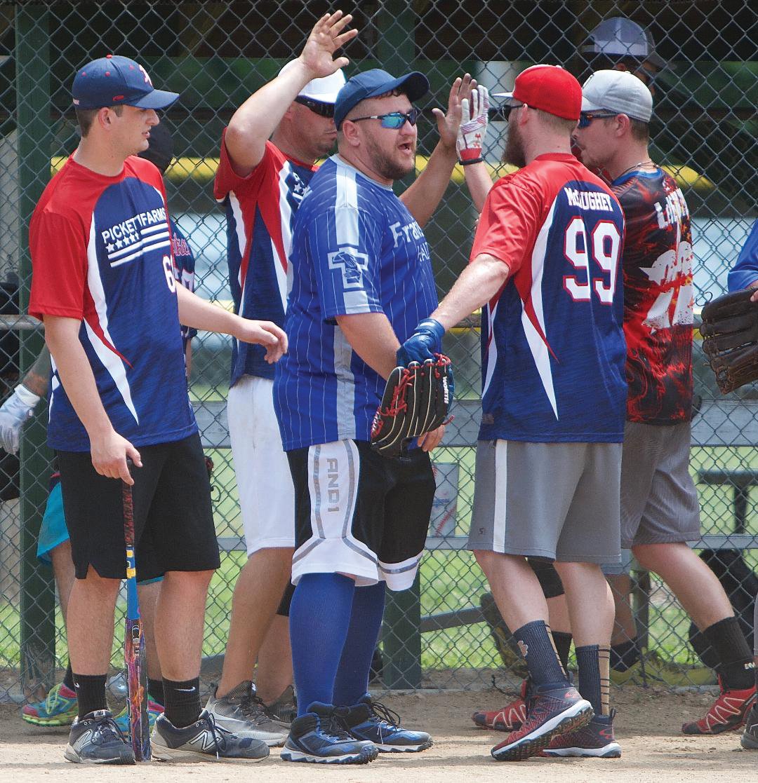 Members of the Pickett Farms softball team give each other high-fives during the Strawberry Festival tournament this weekend. The team finished third.